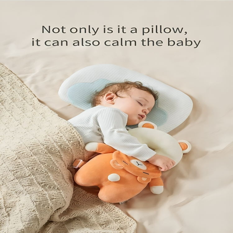 Baby sleeping with a pillow and plush toy on a soft surface
