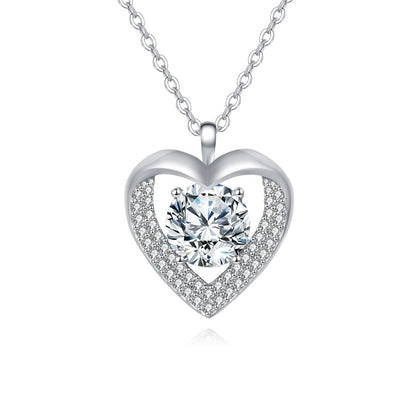 Heart-shaped silver necklace with a central gemstone on a white background