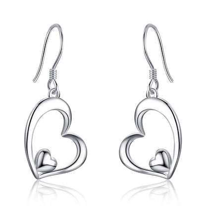 Silver heart-shaped earrings on a white background