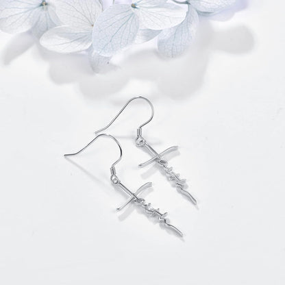 Silver earrings on a white background with light hydrangea flowers