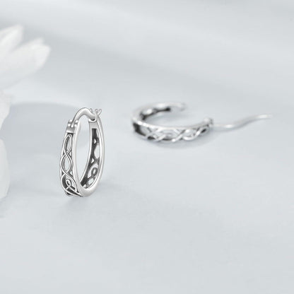 Silver hoop earrings on a light gray background