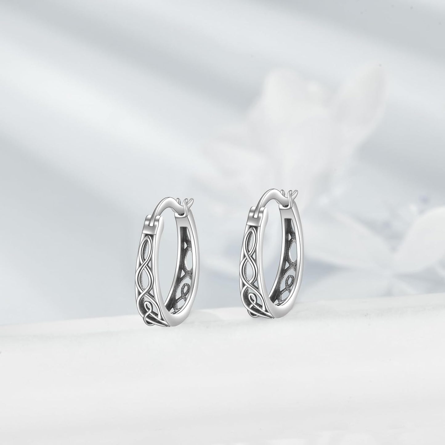 Pair of silver hoop earrings on a light gray background