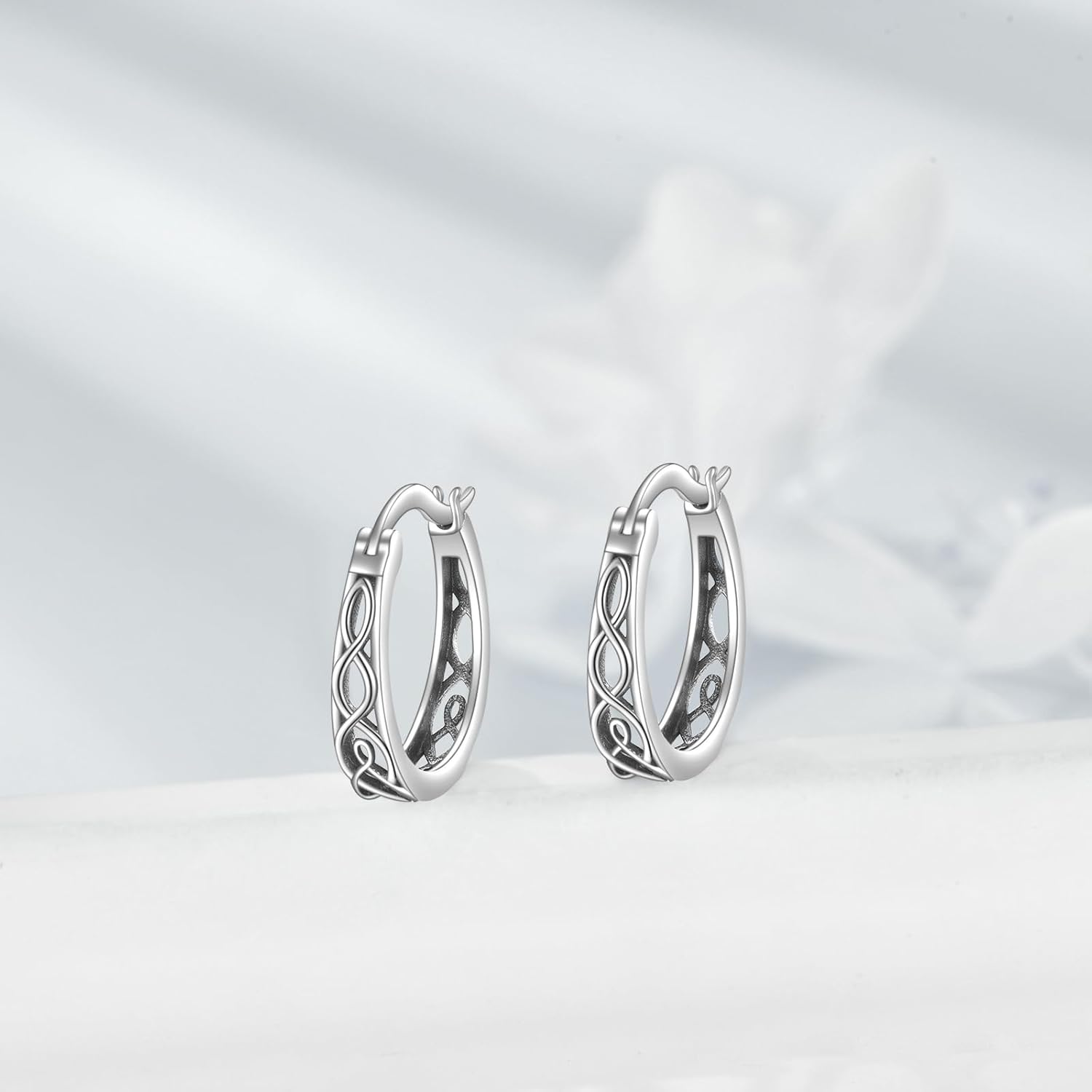 Pair of silver hoop earrings on a light gray background