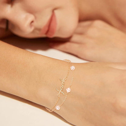 Gold bracelet with pearls on a person's wrist