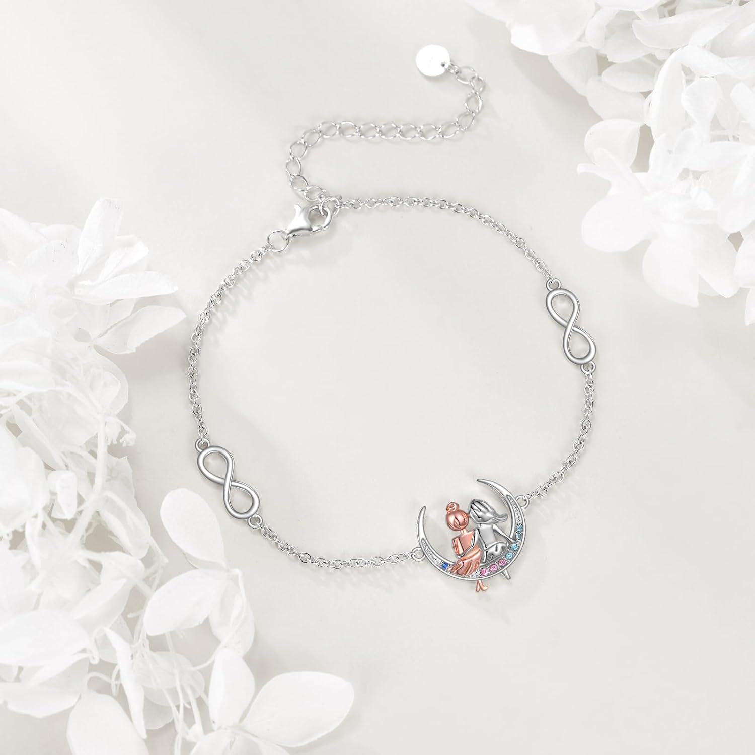 Silver bracelet with heart and infinity symbol on a white background