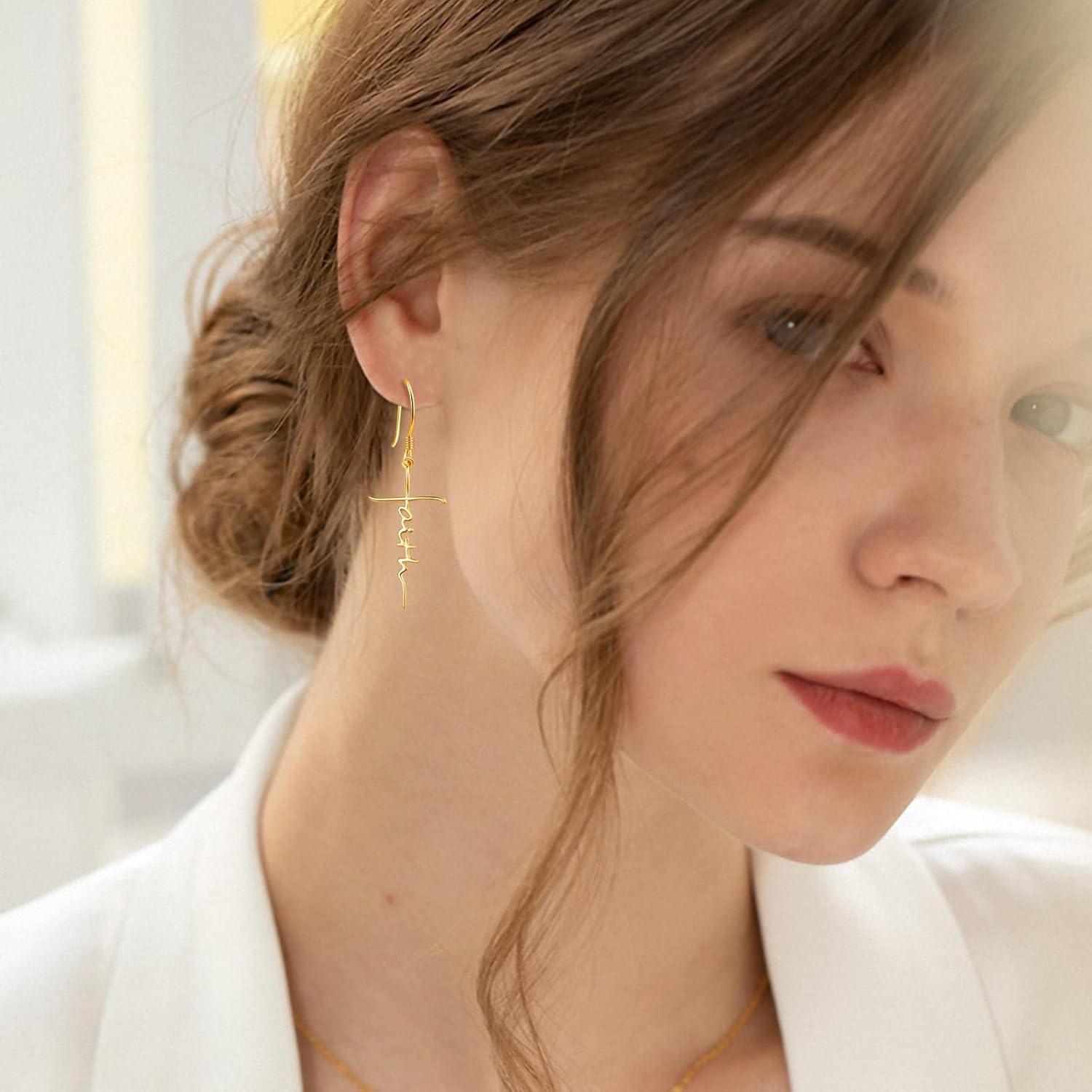 Close-up of a woman wearing gold earrings with a blurred background