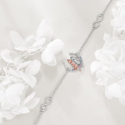 Silver necklace with a heart and infinity symbol pendant on a white floral background