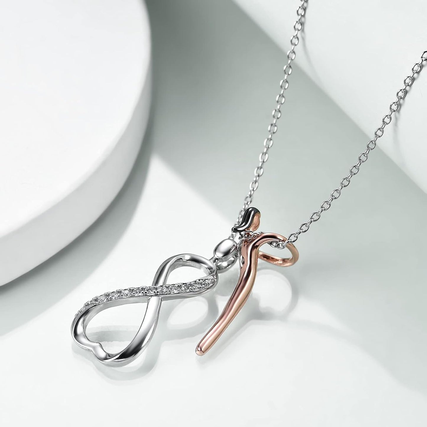 Necklace with infinity symbol pendant on a light background