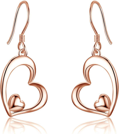 Rose gold heart-shaped earrings on a white background