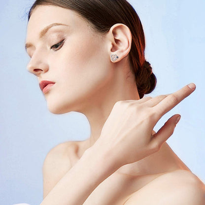 Woman wearing a diamond earring with a light blue background