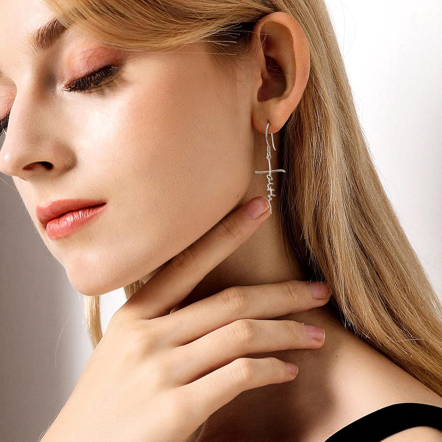 Close-up of a woman wearing a silver earring with a neutral background