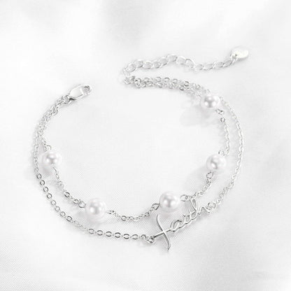 Silver bracelet with pearls on a white background