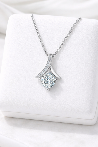Silver necklace with a diamond pendant on a white box