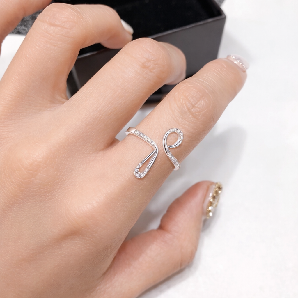 Silver ring on a finger with a white background