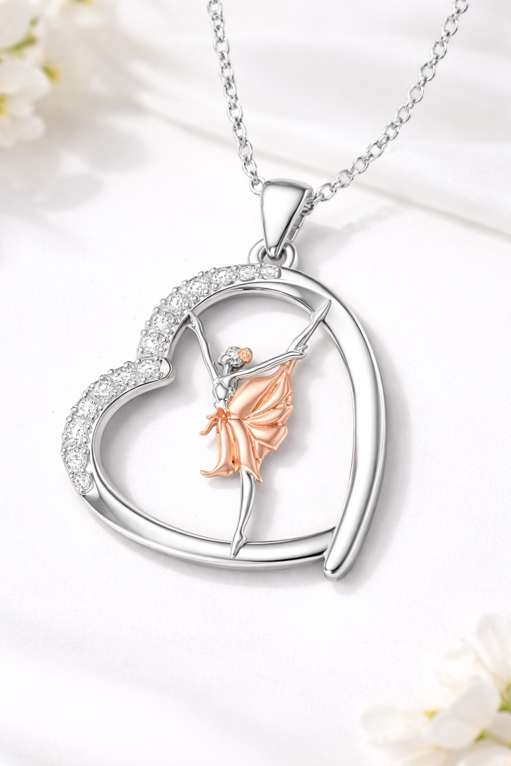 Heart-shaped pendant with a fairy figure on a white background