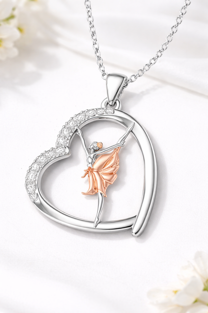 Heart-shaped pendant with a fairy figure on a white background
