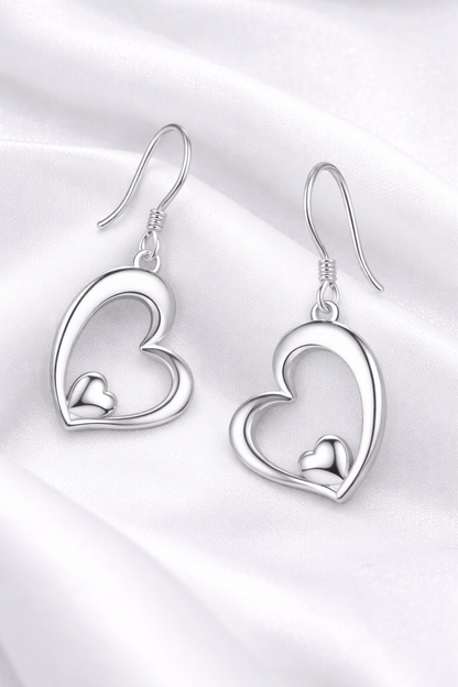 Silver heart-shaped earrings on a white background