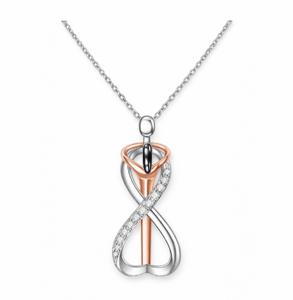 Two-tone infinity pendant necklace on a white background