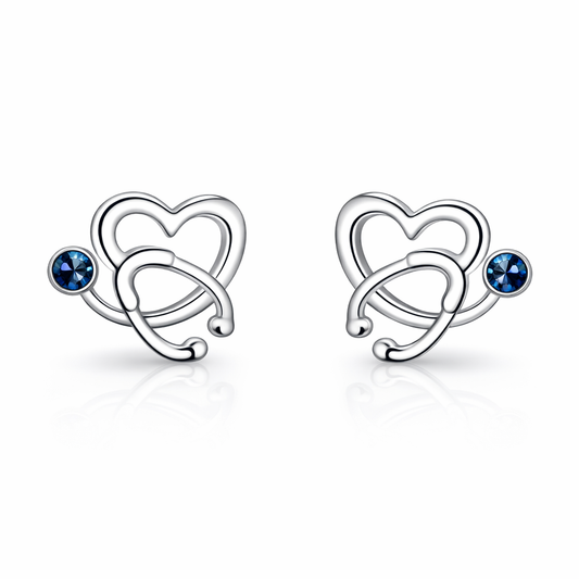 Pair of silver heart-shaped earrings with blue gemstones on a white background