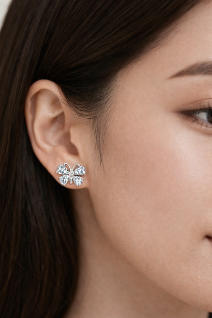 Close-up of a woman wearing a silver earring with gemstones.