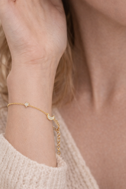 Gold bracelet on a wrist with a soft background
