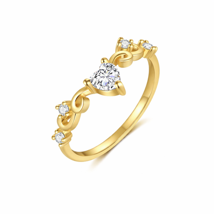 Gold ring with a central diamond and smaller diamonds on a white background