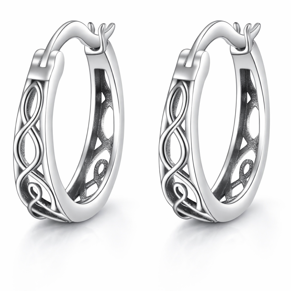 Pair of silver hoop earrings with intricate designs on a white background