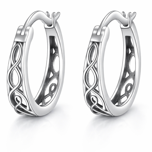 Pair of silver hoop earrings with intricate designs on a white background