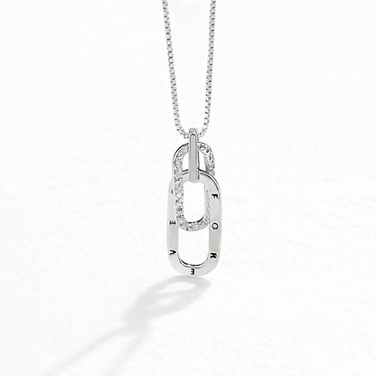 Silver necklace with a pendant on a white background