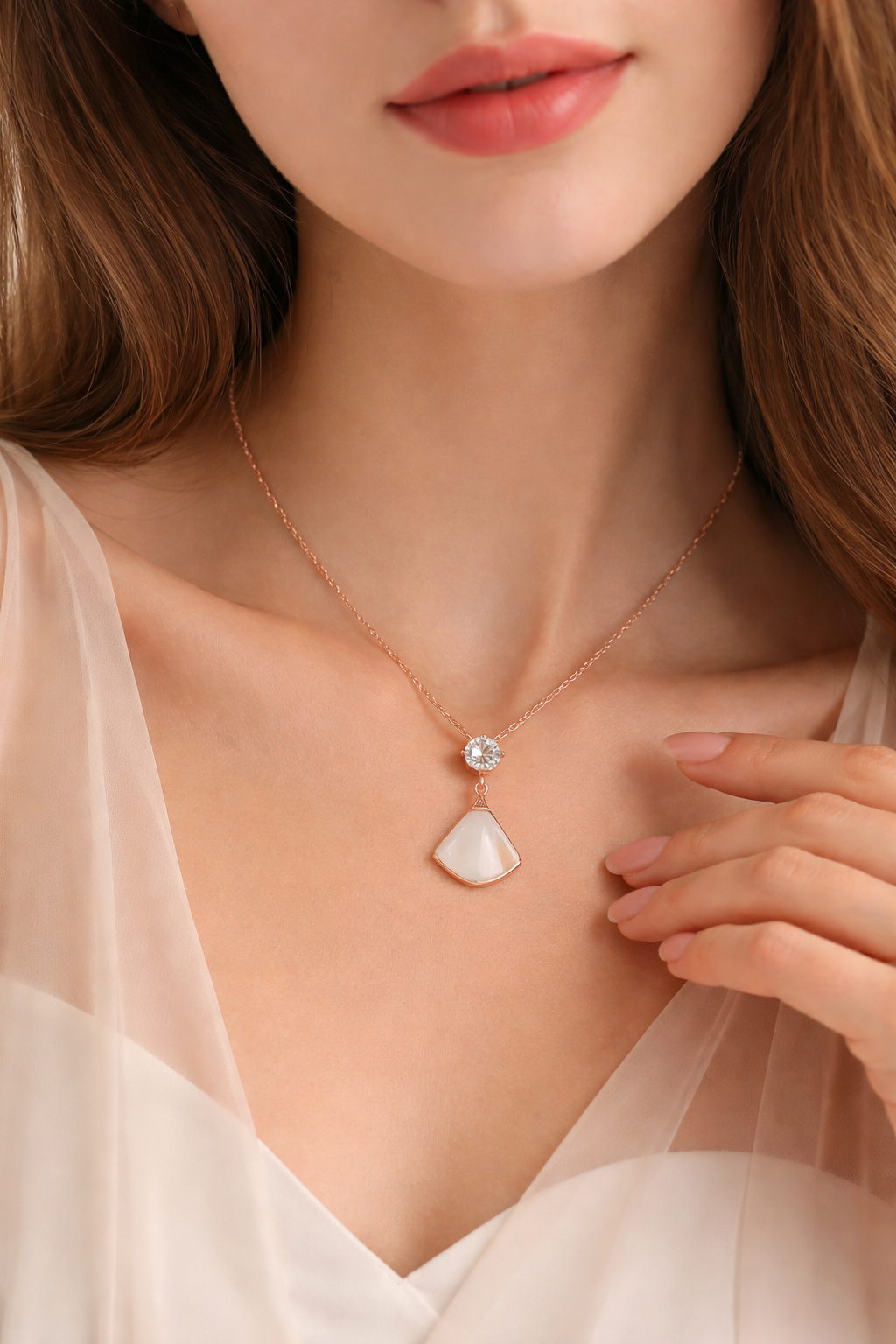 Close-up of a woman wearing a delicate necklace with a pendant.