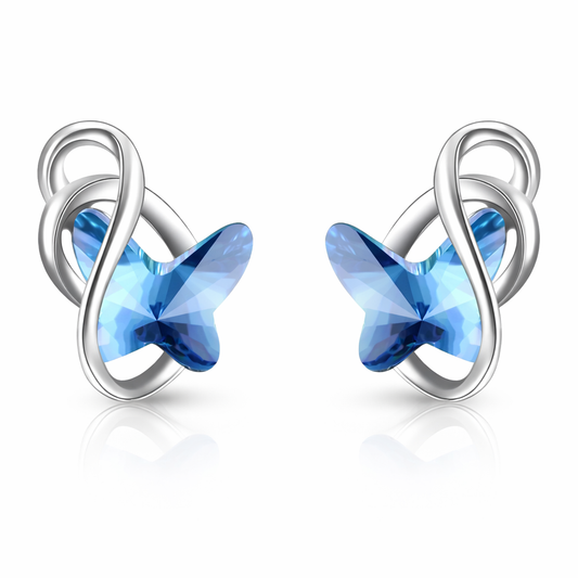 Pair of silver earrings with blue star-shaped crystals on a white background
