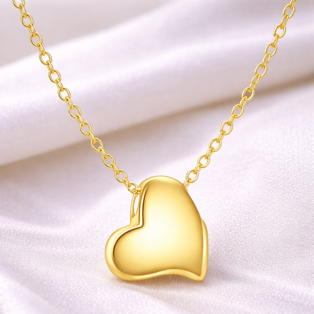Gold heart-shaped pendant necklace on a white background