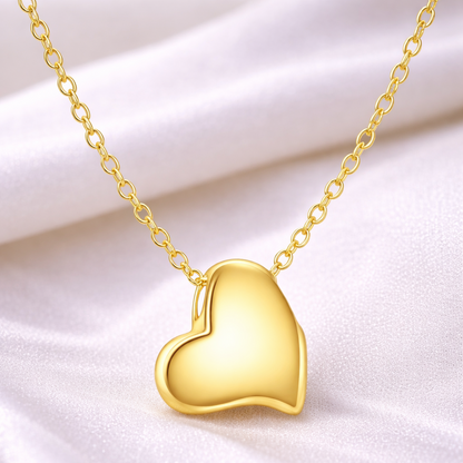 Gold heart-shaped pendant necklace on a white background