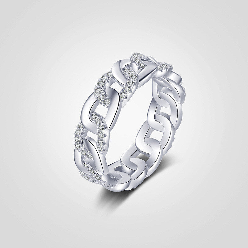 Silver ring with wavy design and small diamonds on a light gray background