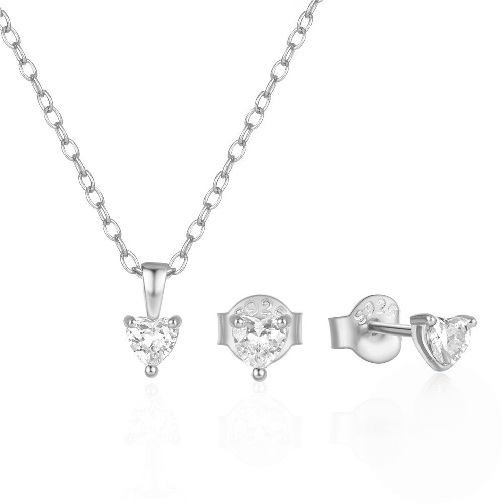 Silver heart-shaped jewelry set with necklace, pendant, and earrings on a white background