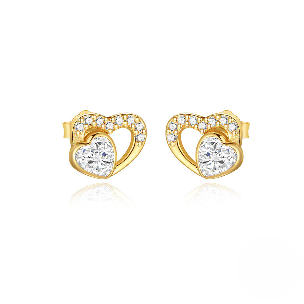 Heart-shaped gold earrings with clear gemstones on a white background