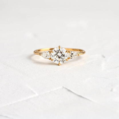 Gold ring with a diamond on a light gray background