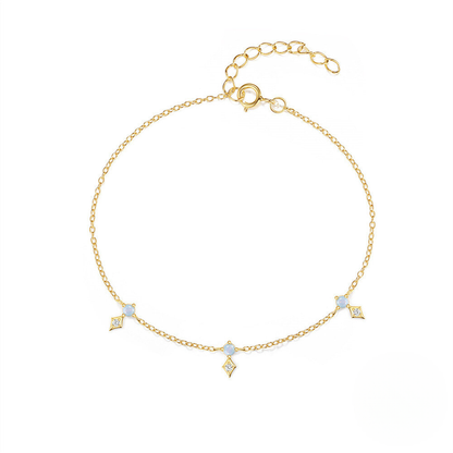 Gold bracelet with diamond-shaped charms on a white background