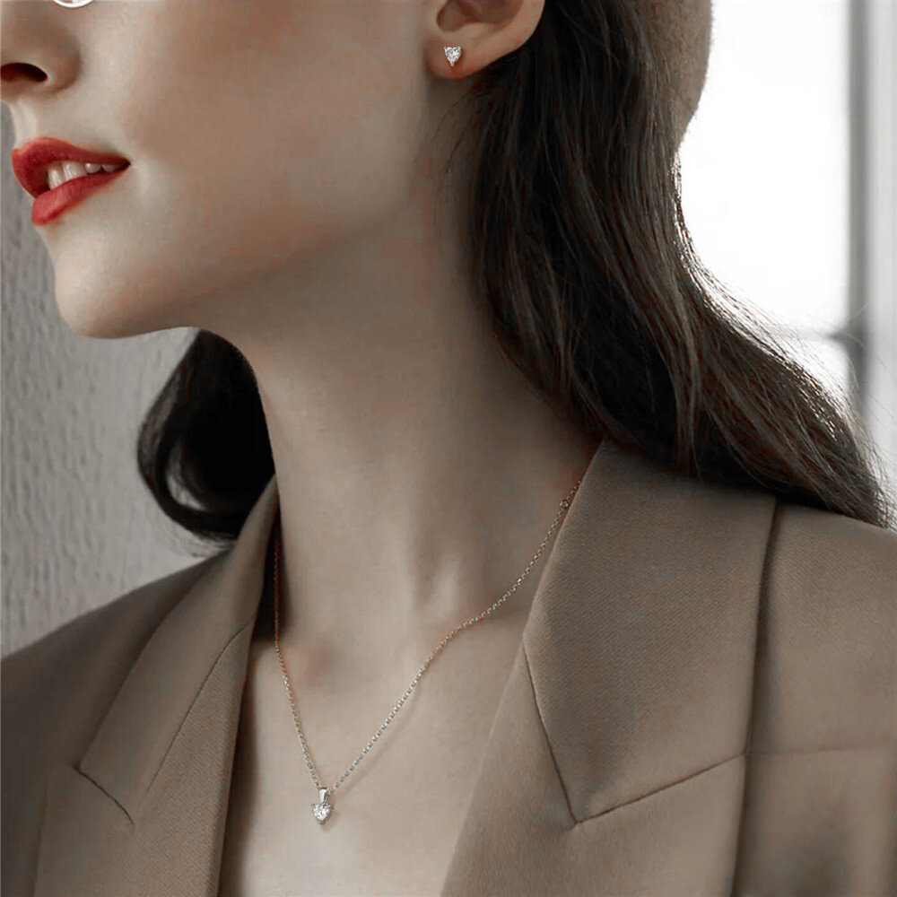 Close-up of a woman wearing a delicate necklace and earring set.