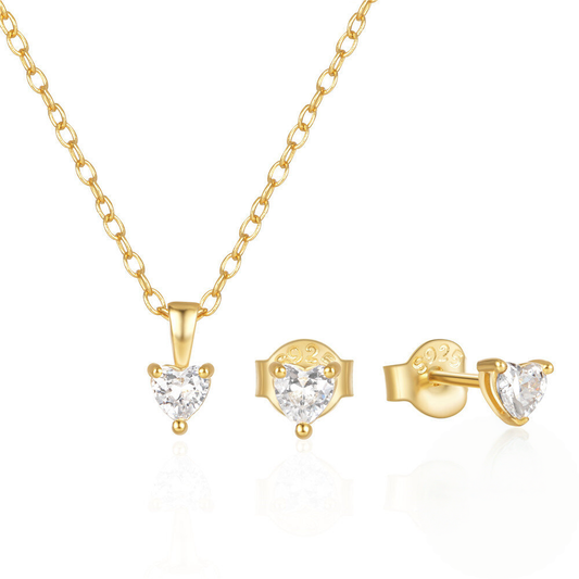 Gold jewelry set with heart-shaped gemstones on a white background