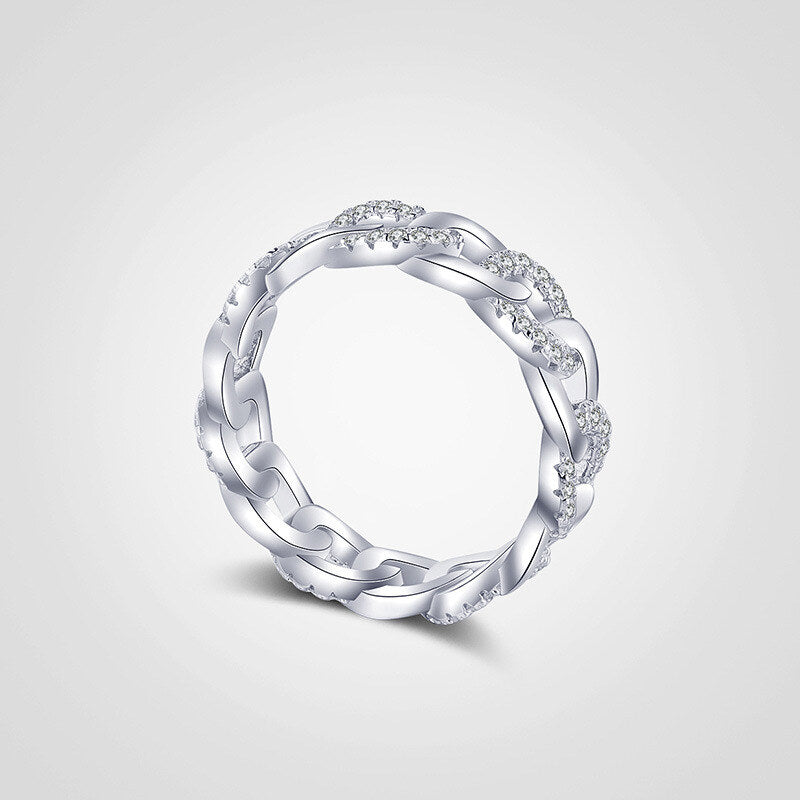 Silver ring with intricate design on a light gray background