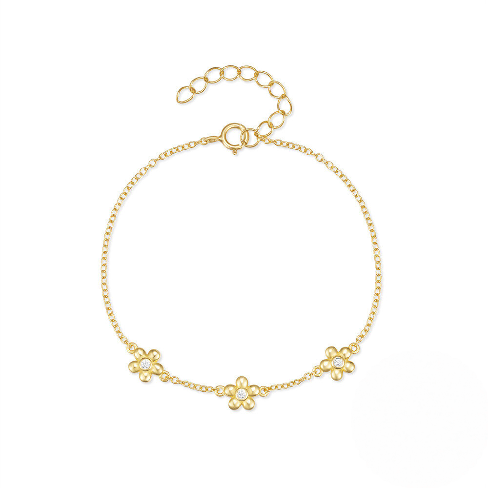 Gold bracelet with floral designs on a white background