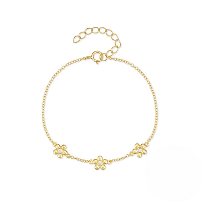 Gold bracelet with floral designs on a white background
