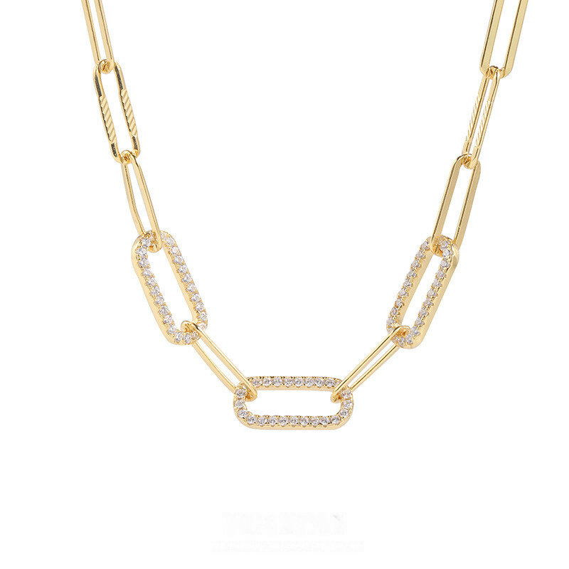 Gold chain necklace with interlocking links on a white background