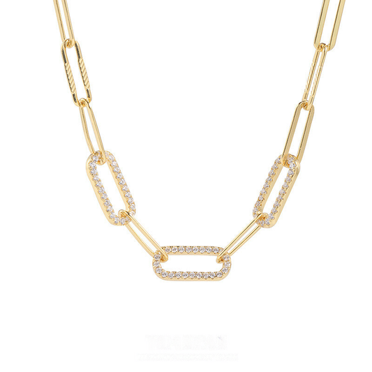 Gold chain necklace with interlocking links on a white background