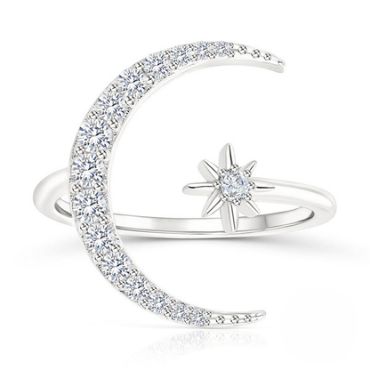 Silver ring with moon and star design on a white background