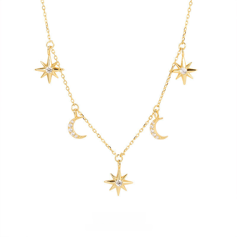 Gold necklace with star and moon pendants on a white background