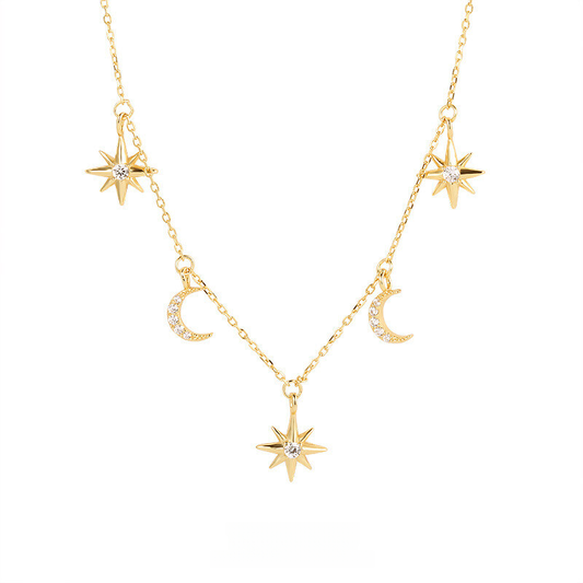 Gold necklace with star and moon pendants on a white background