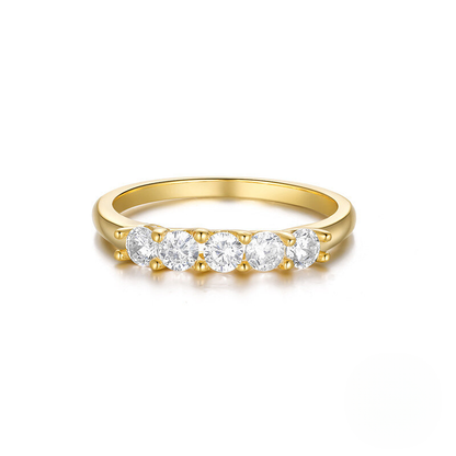 Gold ring with four diamonds on a white background