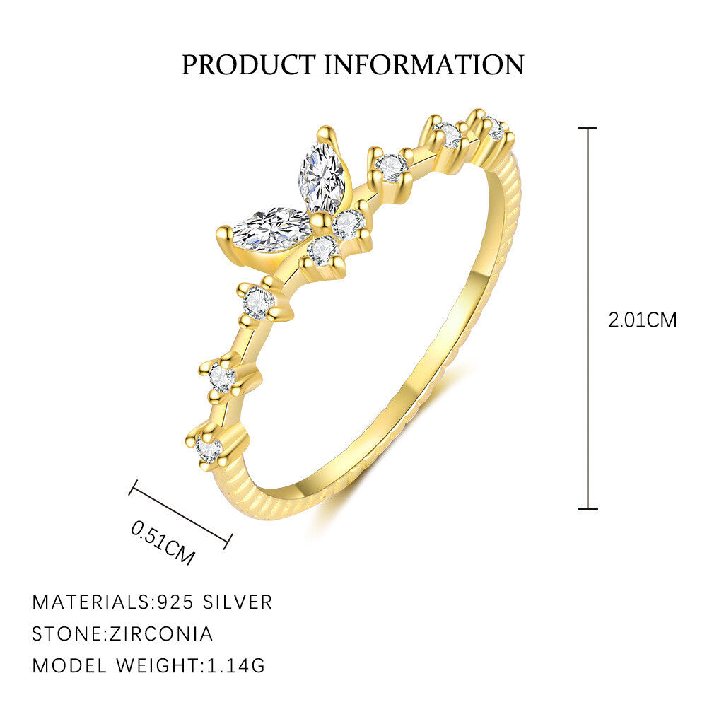 Gold ring with zirconia stones and product information on a white background